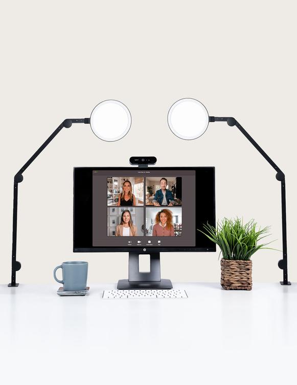 Desktop setup with two Lume Cube Edge Lights and a monitor showing a video conference.