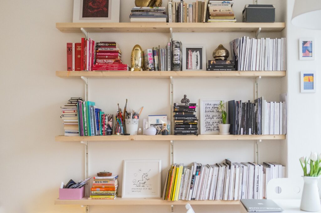 A modern bookcase with personal items that give off a lot of personality